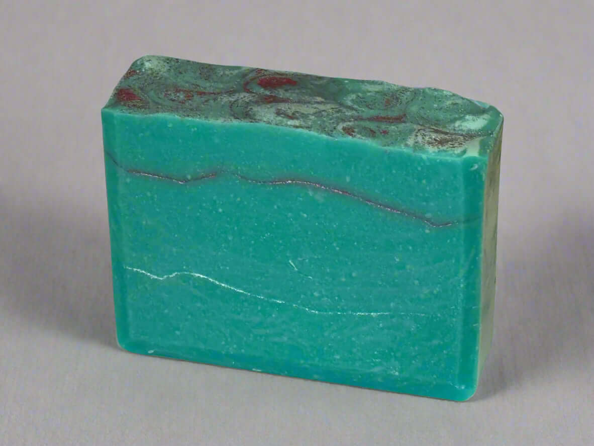 Vibrant handmade soap bar in soothing turquoise with elegant marbled patterns, perfect for nourishing your skin.