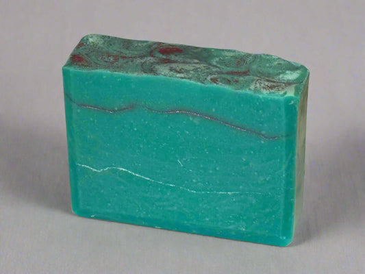 Vibrant handmade soap bar in soothing turquoise with elegant marbled patterns, perfect for nourishing your skin.