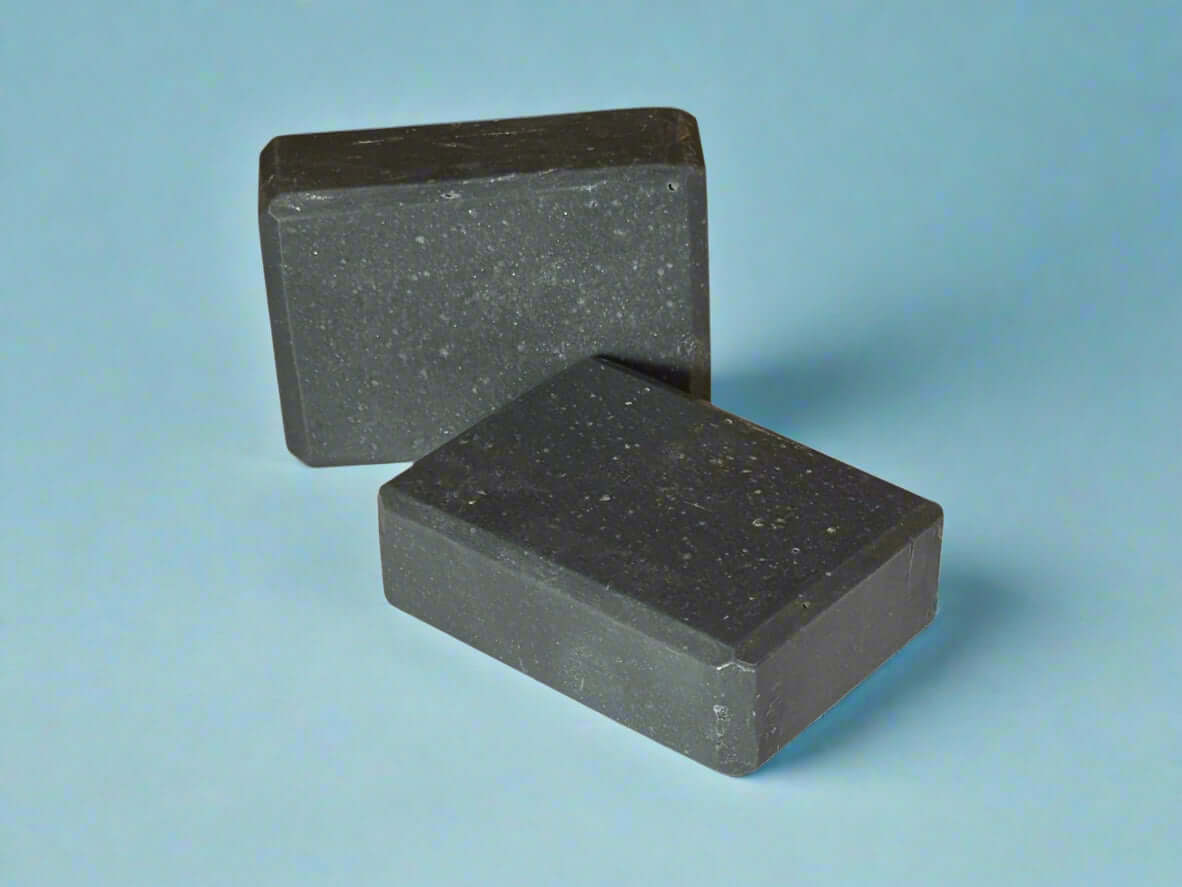 Fellas soap for men in dark hues, featuring a wet leather fragrance for a sophisticated shower experience.